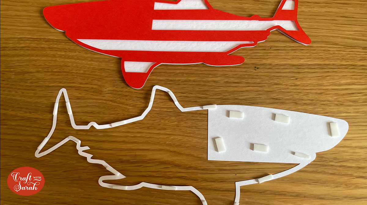 Use foam pads to stick the second white layer onto the red layer