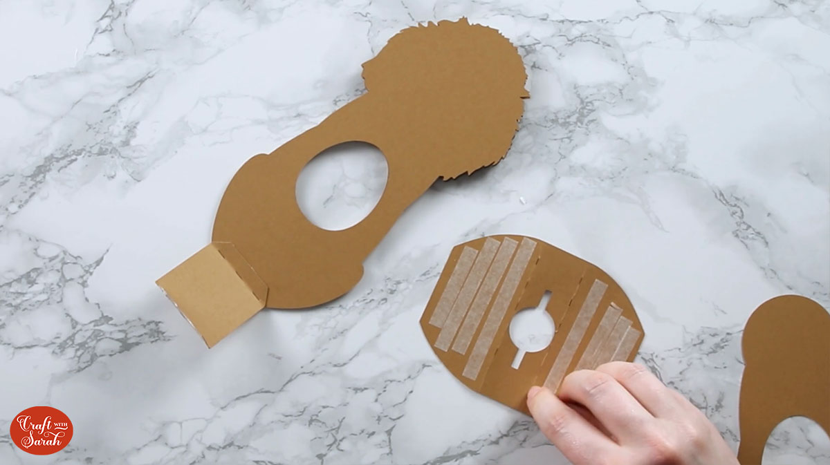 Add double-sided tape to both of the "flaps"/sides of the larger base piece.